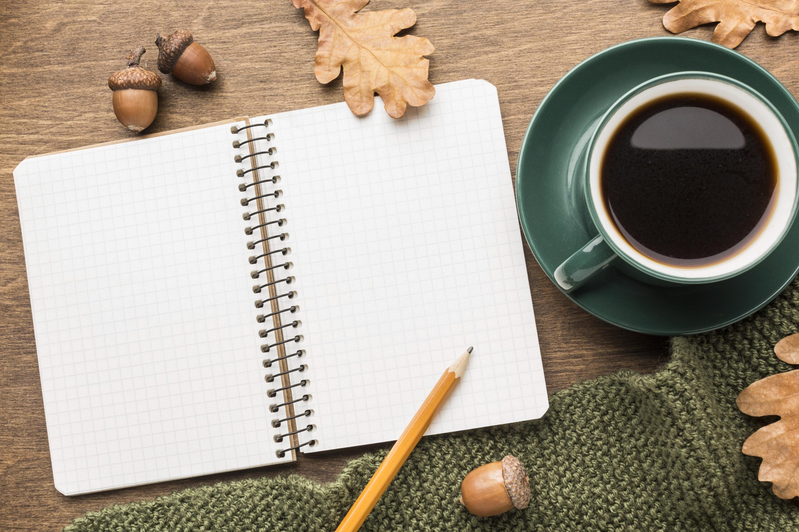 top-view-coffee-with-notebook-autumn-leaves